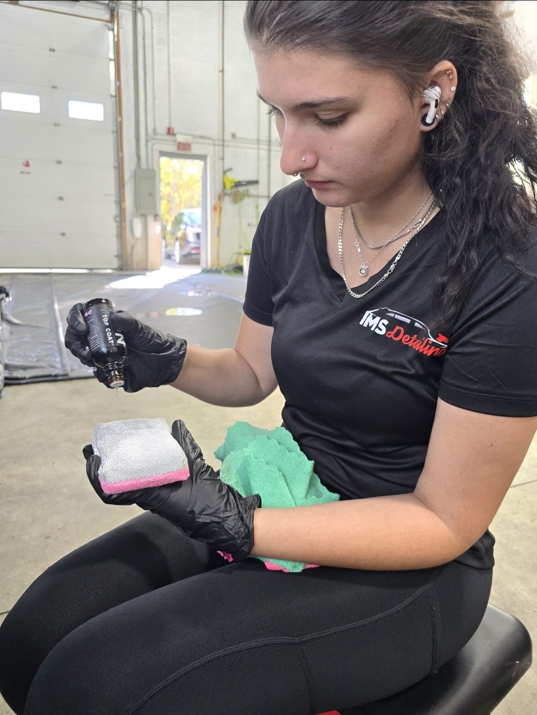 Destinee applying ceramic coating top coat at IMS Detailing in Hooksett