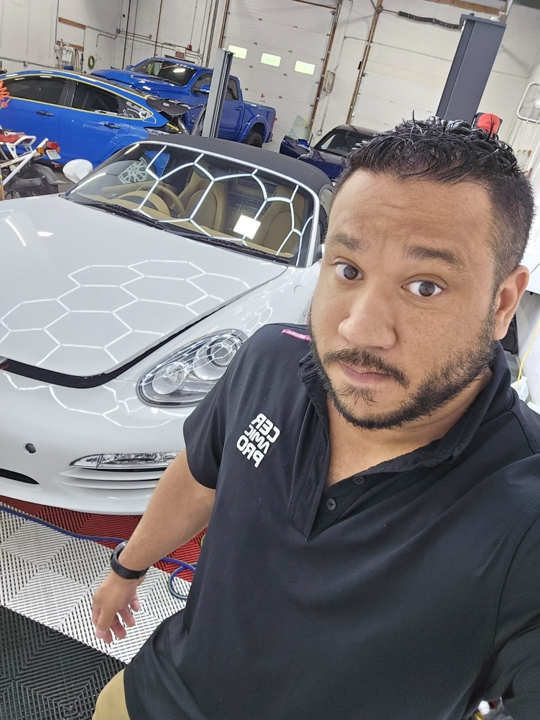 JP, owner of IMS Detailing, in the Hooksett shop with a customer vehicle